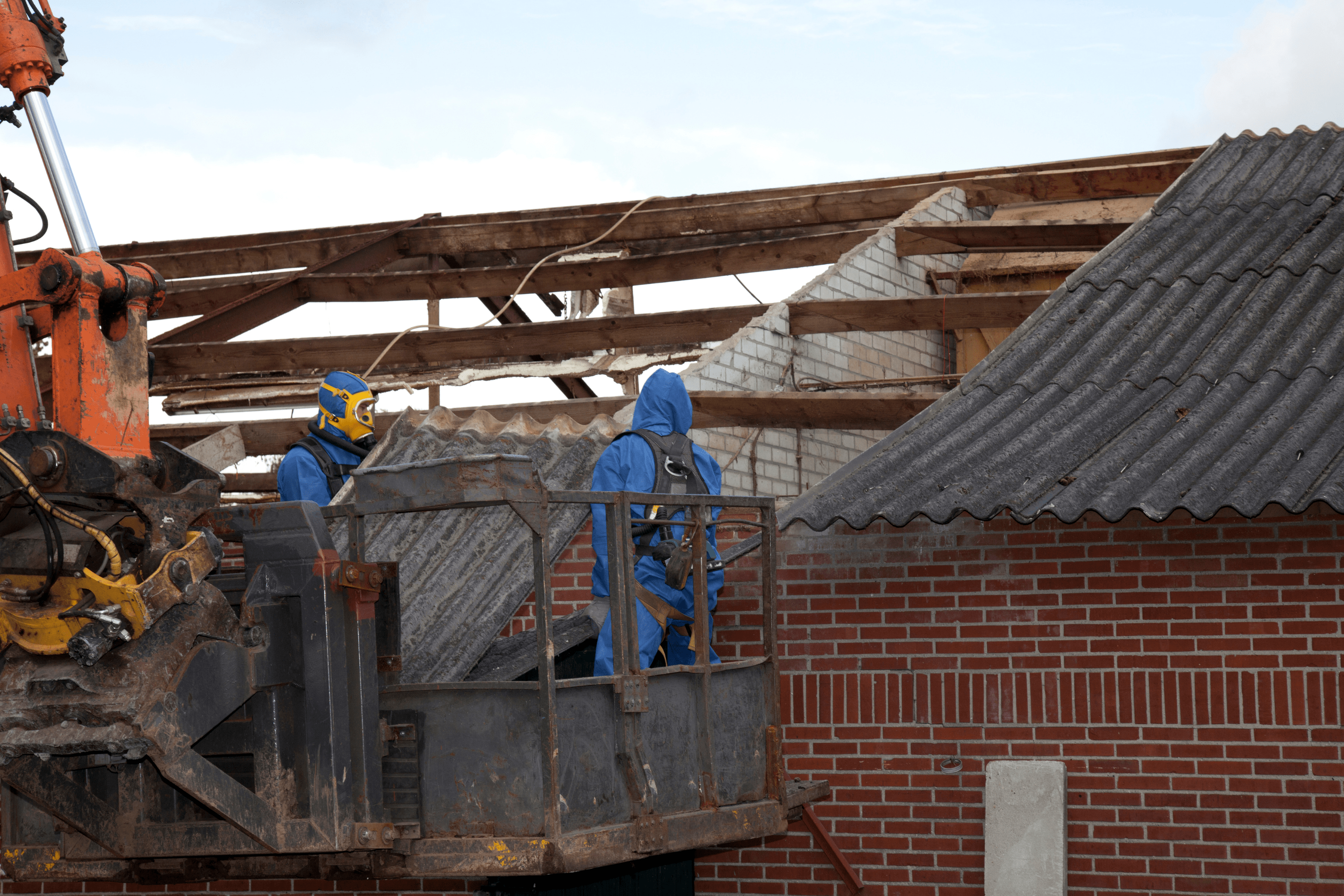 Asbestos removalists removing asbestos from an old home.