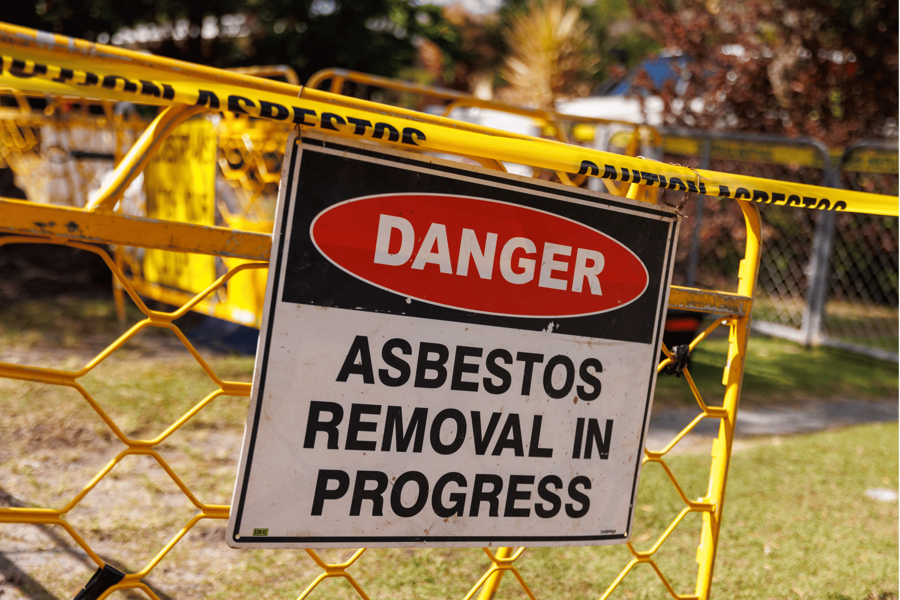 Danger: Asbestos Removal In Progress sign.