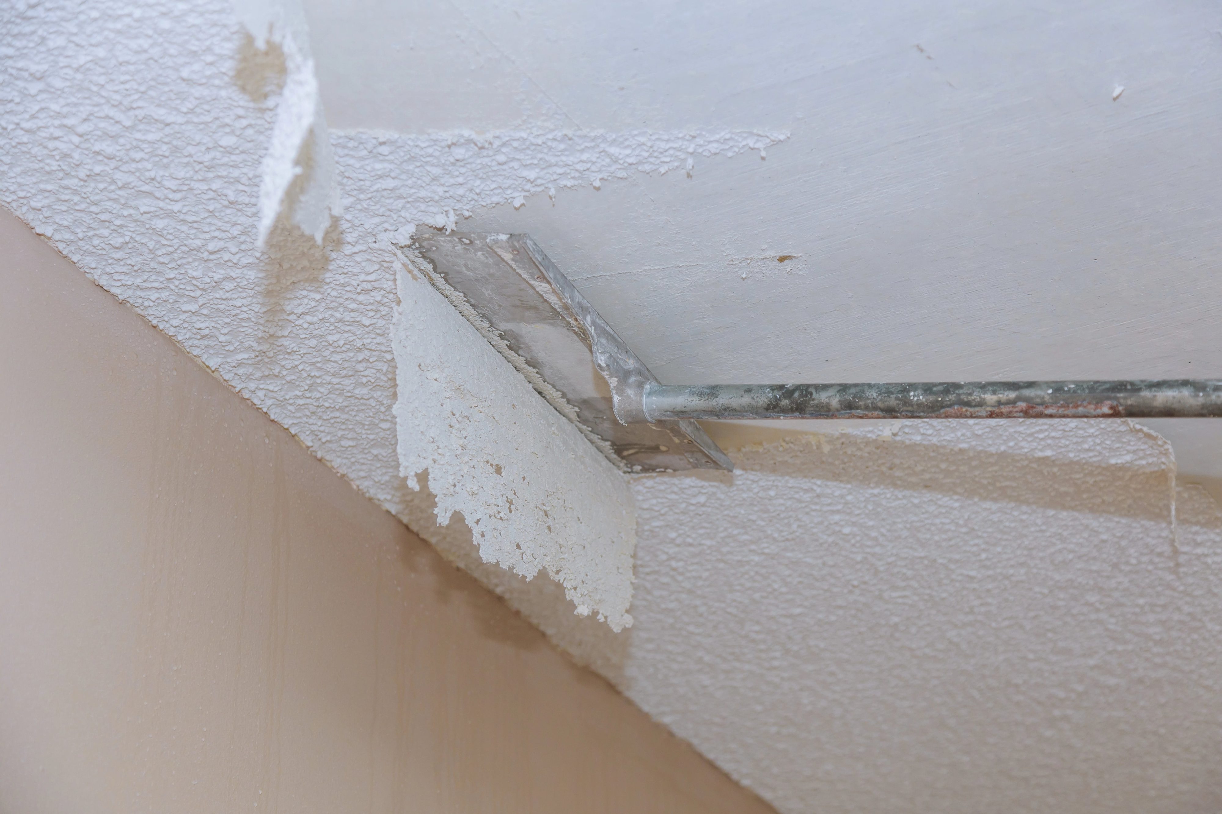 Scraping popcorn ceiling.